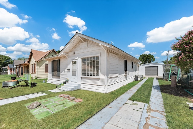 view of front of property with an outbuilding, a front yard, and a garage