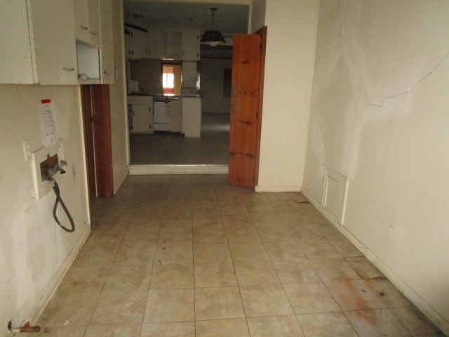 corridor featuring light tile patterned floors