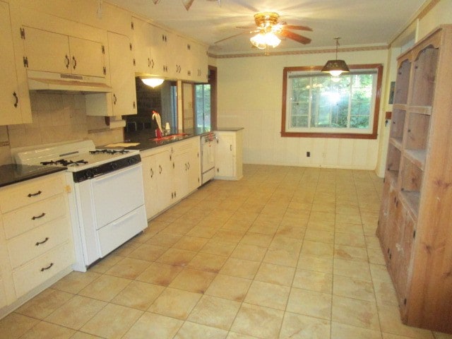 kitchen with ornamental molding, white appliances, sink, ceiling fan, and decorative backsplash