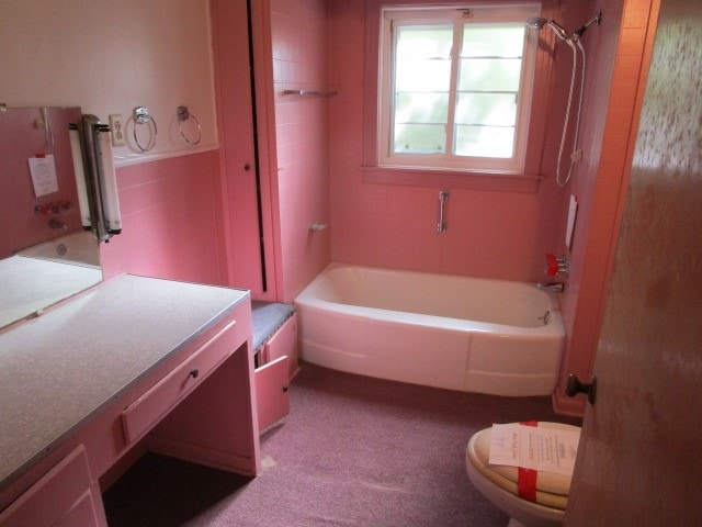 full bathroom featuring vanity, toilet, and tiled shower / bath combo