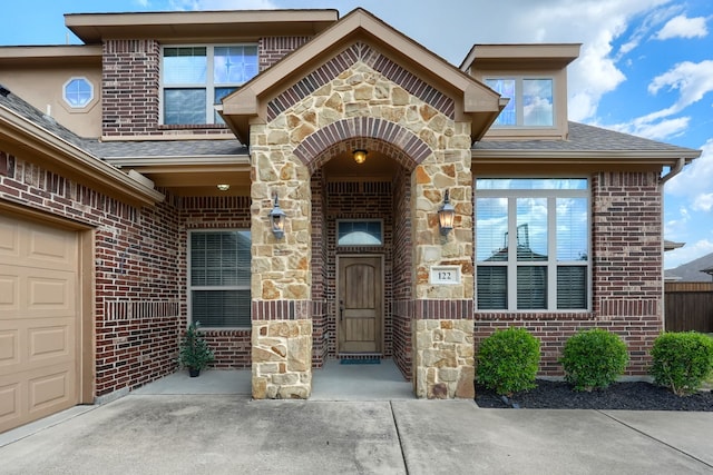 doorway to property with a garage