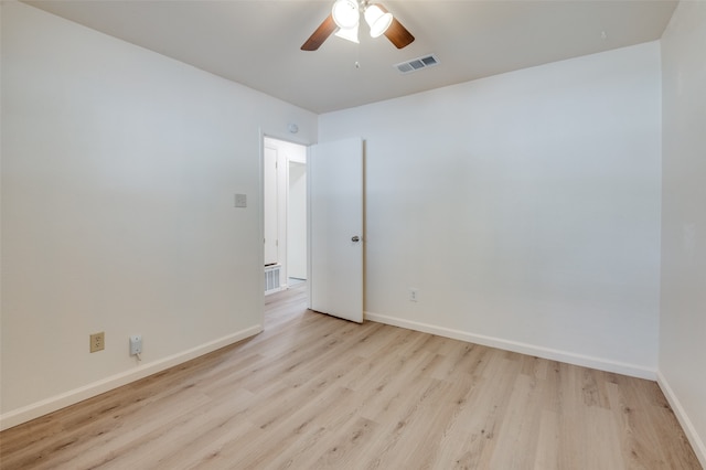 spare room featuring light wood-type flooring and ceiling fan