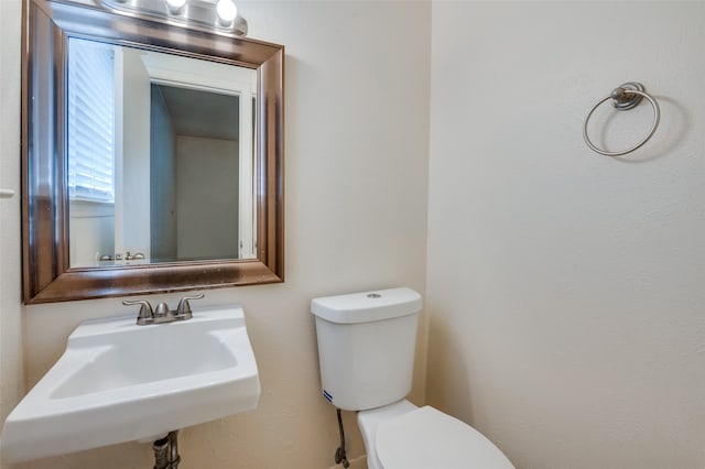 bathroom with toilet and sink