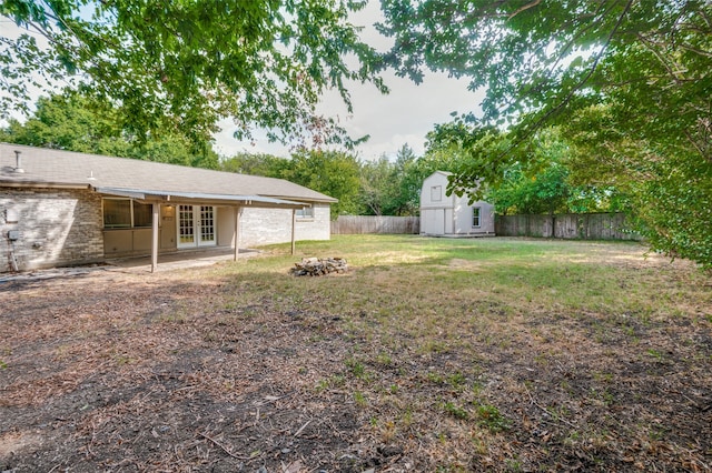 view of yard with a patio and a storage unit