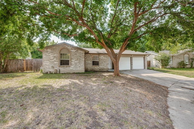 ranch-style house with a garage and a front lawn