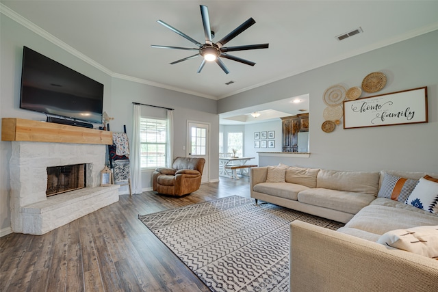 living room with ornamental molding, wood-type flooring, and ceiling fan