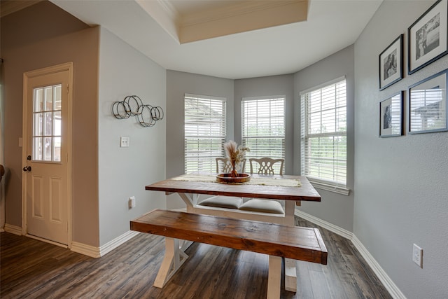 dining space with dark hardwood / wood-style flooring and ornamental molding