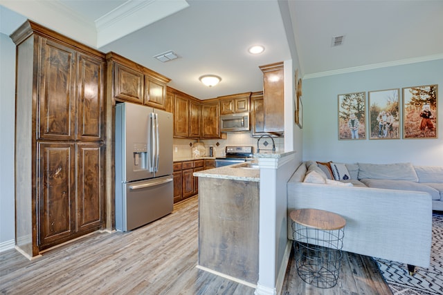 kitchen with light wood-type flooring, crown molding, light stone counters, kitchen peninsula, and appliances with stainless steel finishes