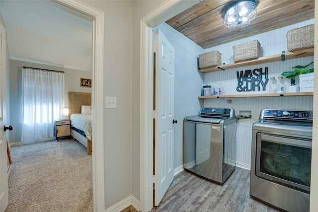 washroom featuring washer and clothes dryer and light hardwood / wood-style flooring