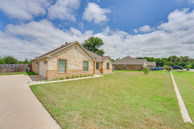 ranch-style home featuring a garage and a front yard