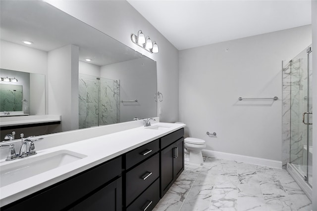 bathroom featuring vanity, toilet, and a shower with door