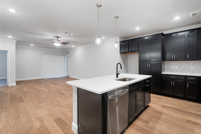 kitchen with sink, hanging light fixtures, light hardwood / wood-style flooring, dishwasher, and a kitchen island with sink