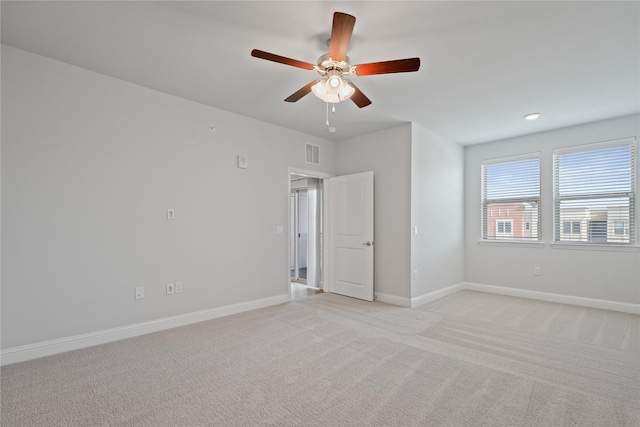 empty room featuring light colored carpet and ceiling fan