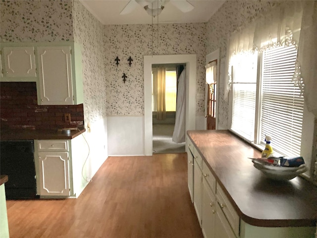 kitchen featuring light hardwood / wood-style flooring, ceiling fan, backsplash, and white cabinets