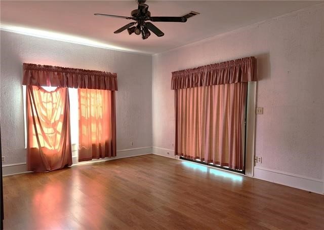 unfurnished room featuring ceiling fan and hardwood / wood-style flooring