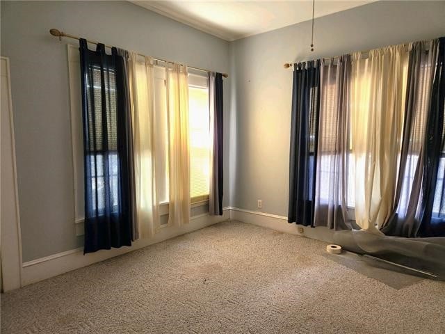 carpeted spare room with a healthy amount of sunlight