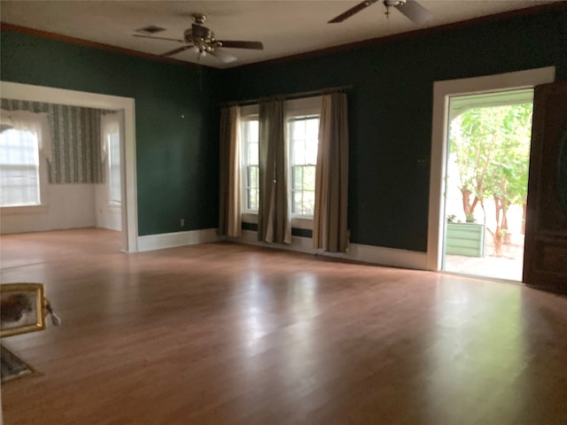 empty room with ceiling fan and hardwood / wood-style flooring