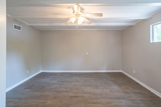 unfurnished room with ceiling fan, dark hardwood / wood-style flooring, and beam ceiling