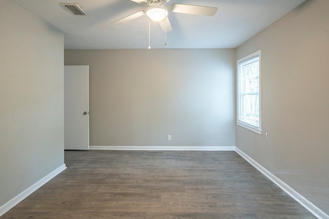 unfurnished room with ceiling fan and dark hardwood / wood-style floors