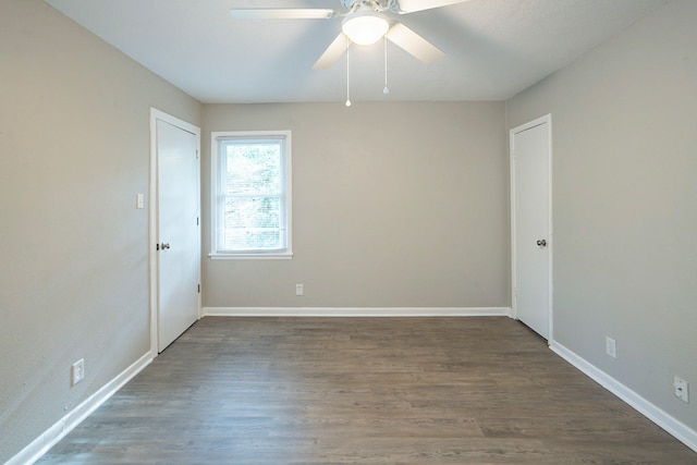 unfurnished room featuring ceiling fan and dark hardwood / wood-style floors