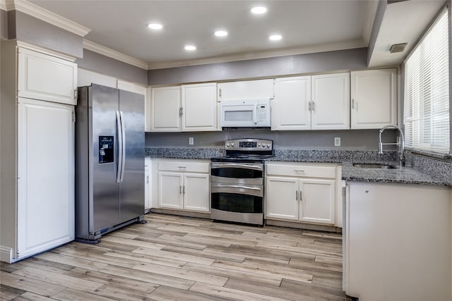 kitchen featuring white cabinets, sink, light hardwood / wood-style flooring, appliances with stainless steel finishes, and crown molding