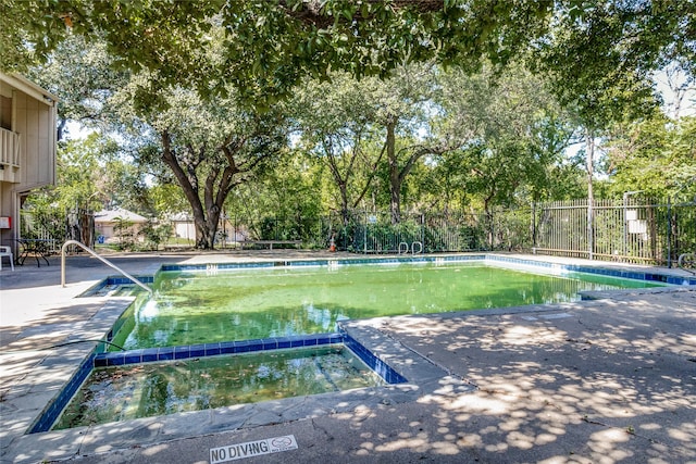 view of property's community featuring a swimming pool and a patio area