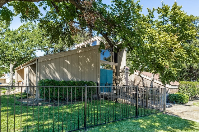 view of side of home featuring a yard