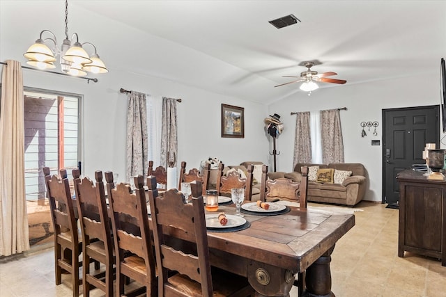 dining room featuring vaulted ceiling and ceiling fan with notable chandelier