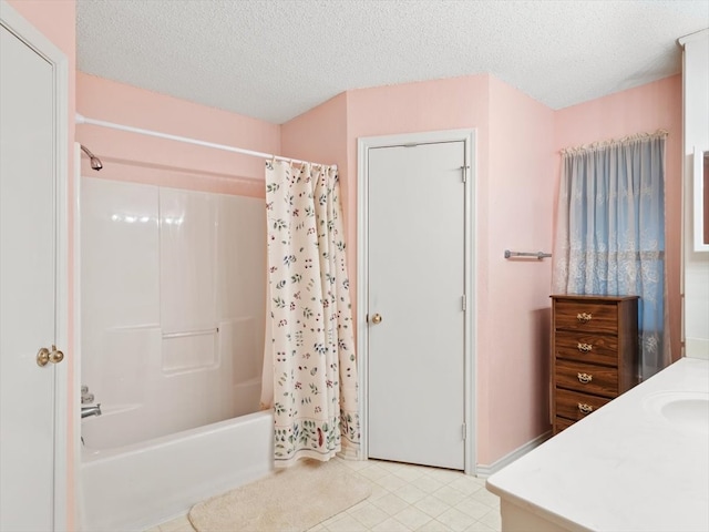 bathroom with a textured ceiling, vanity, and shower / bathtub combination with curtain