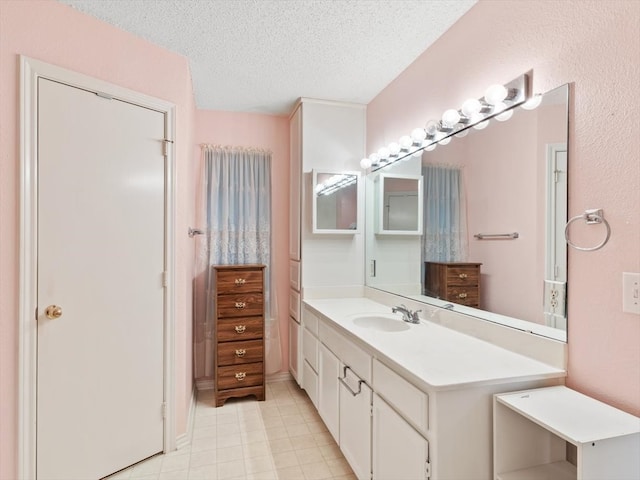 bathroom with a textured ceiling and vanity