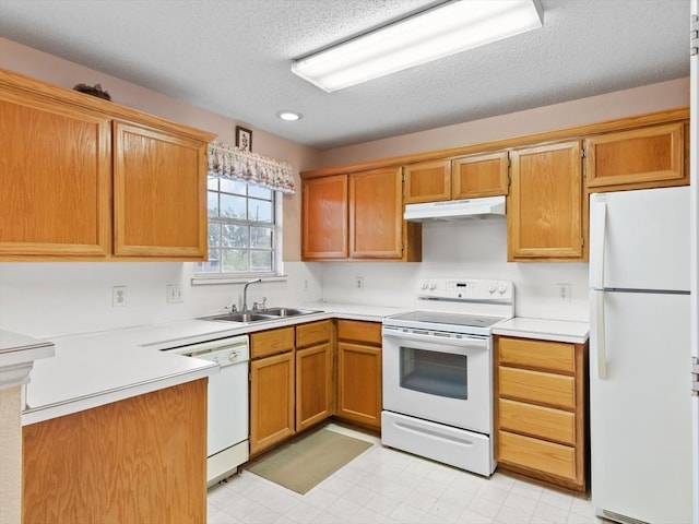 kitchen featuring a textured ceiling, sink, and white appliances