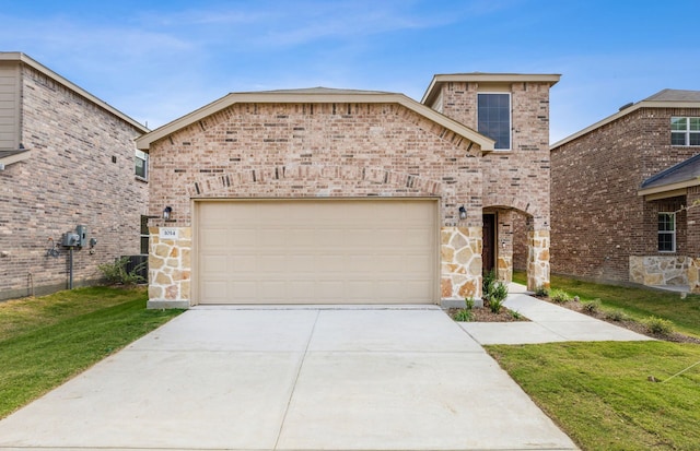 view of front of house featuring a garage and a front yard