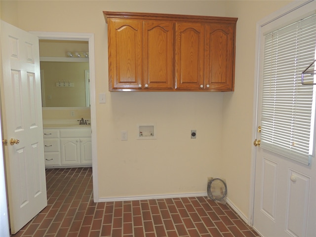 laundry room with washer hookup, cabinets, electric dryer hookup, and sink