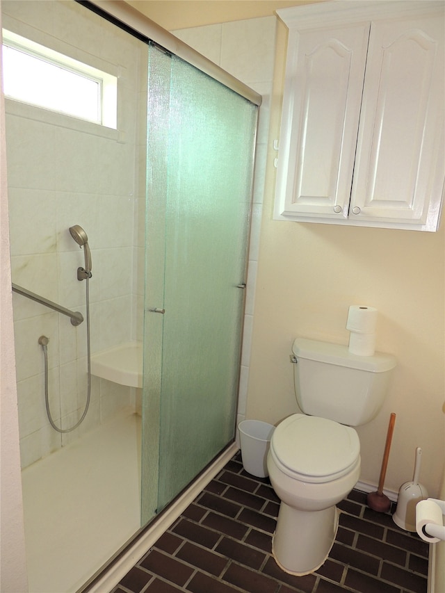 bathroom featuring toilet and walk in shower