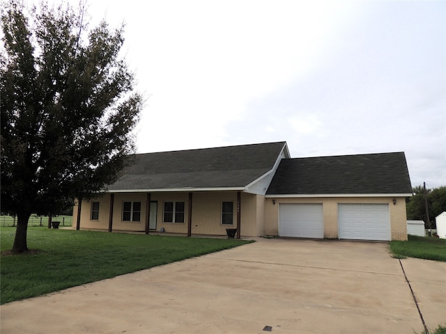 single story home with a garage and a front lawn