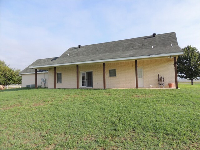 rear view of property featuring a yard and french doors