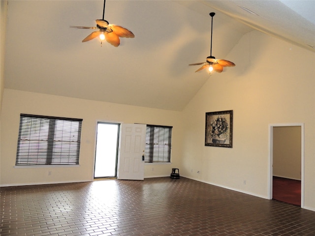 unfurnished room with ceiling fan and high vaulted ceiling