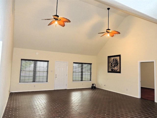 unfurnished living room featuring high vaulted ceiling and ceiling fan