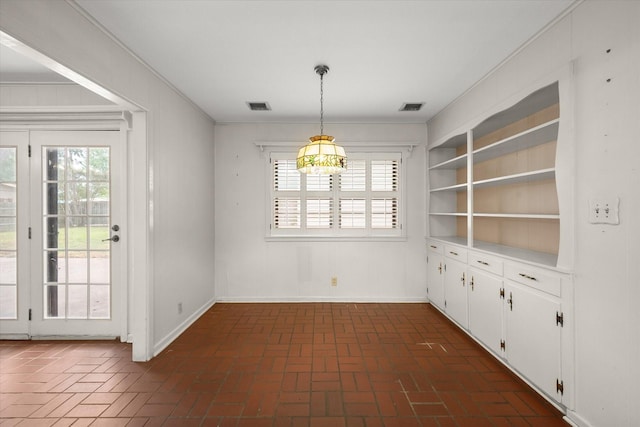 unfurnished dining area with ornamental molding