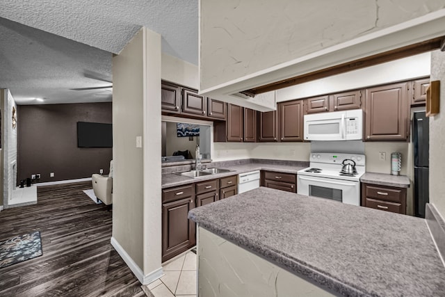 kitchen featuring a textured ceiling, ceiling fan, sink, and white appliances