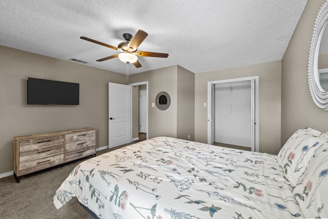 bedroom with a textured ceiling, carpet, ceiling fan, and a closet