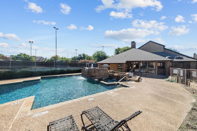 view of swimming pool with a patio and pool water feature