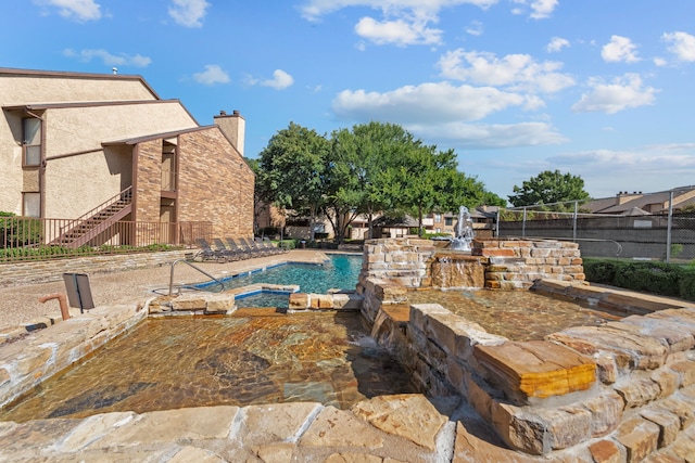 view of swimming pool featuring pool water feature