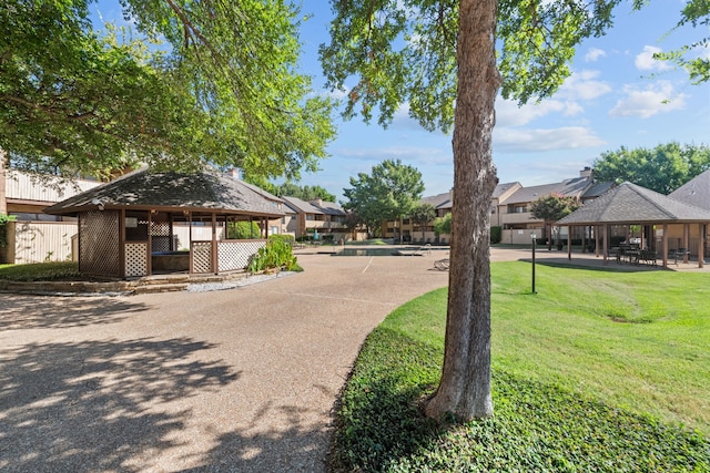 view of front of property with a front lawn and a gazebo