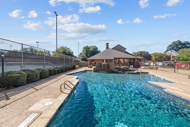 view of swimming pool featuring pool water feature