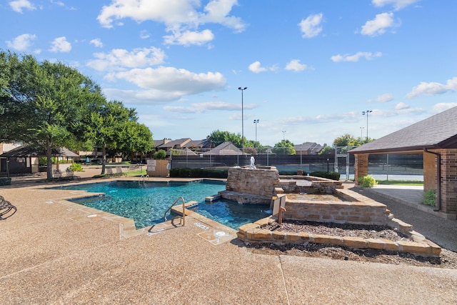 view of swimming pool with a patio area