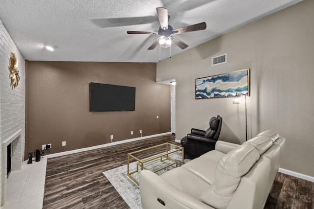 living room featuring a fireplace, lofted ceiling, hardwood / wood-style floors, and ceiling fan