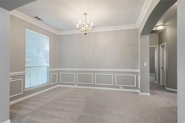 spare room featuring light colored carpet, a wealth of natural light, and an inviting chandelier