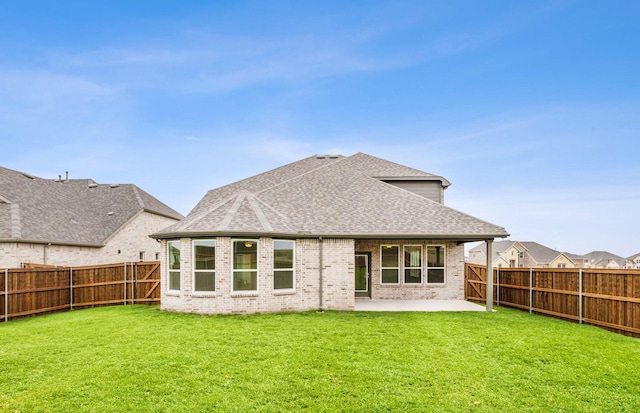 back of house with a patio area and a yard