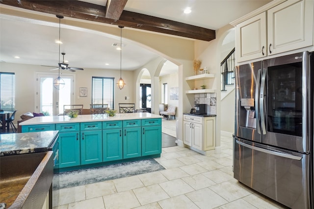 kitchen with hanging light fixtures, blue cabinetry, beamed ceiling, ceiling fan, and stainless steel fridge with ice dispenser